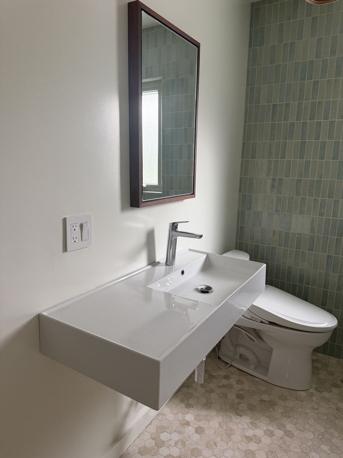 Remodeled bathroom sink and tile wall
