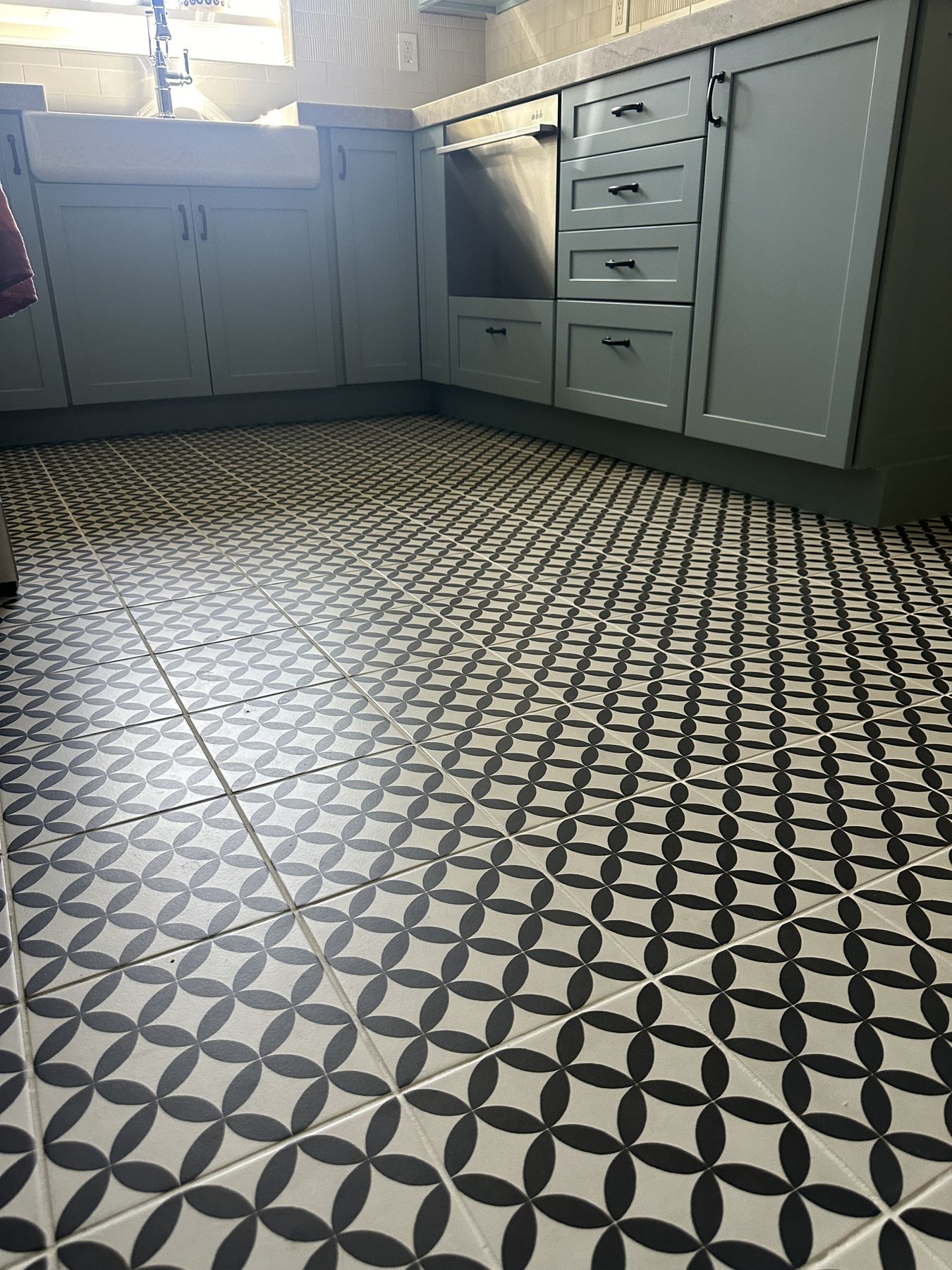 Patterned tile floor running up to the base cabinets